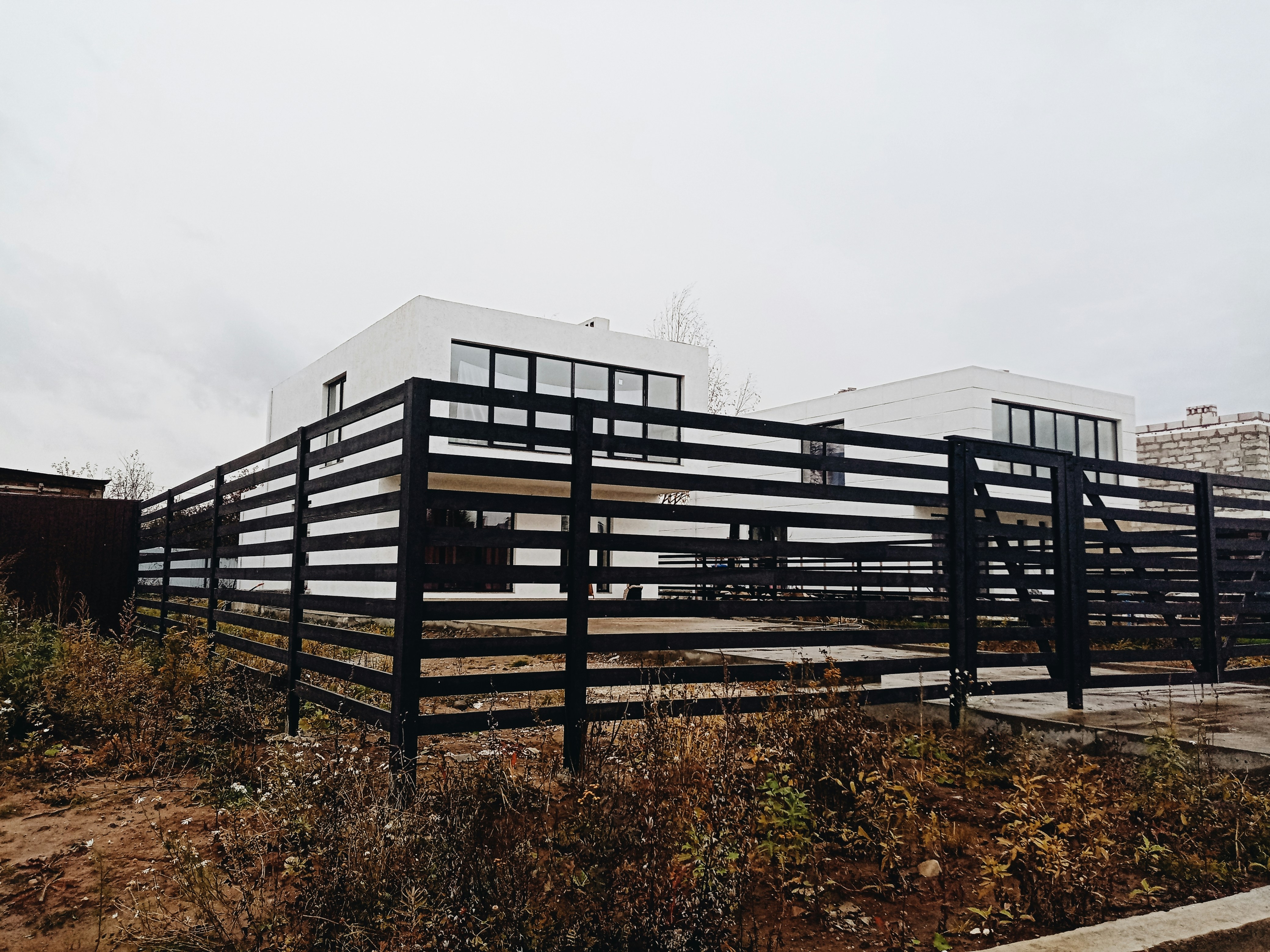 Modern horizontal slat fence in dark finish with contemporary design for urban setting